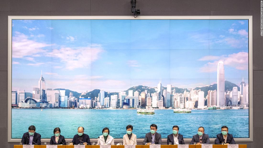 Hong Kong Chief Executive Carrie Lam, center, attends a news conference in Hong Kong on January 28. Lam said China will stop individual travelers to Hong Kong while closing some border checkpoints and restricting flights and train services from the mainland.